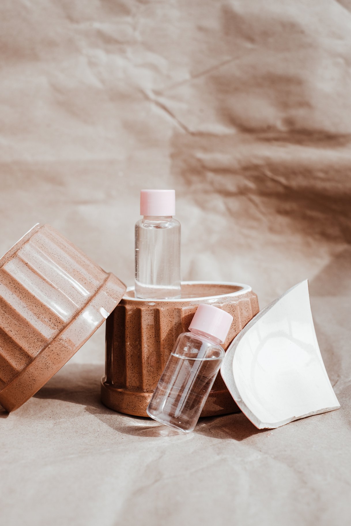 Clear Glass Bottles on Ceramic Bowls